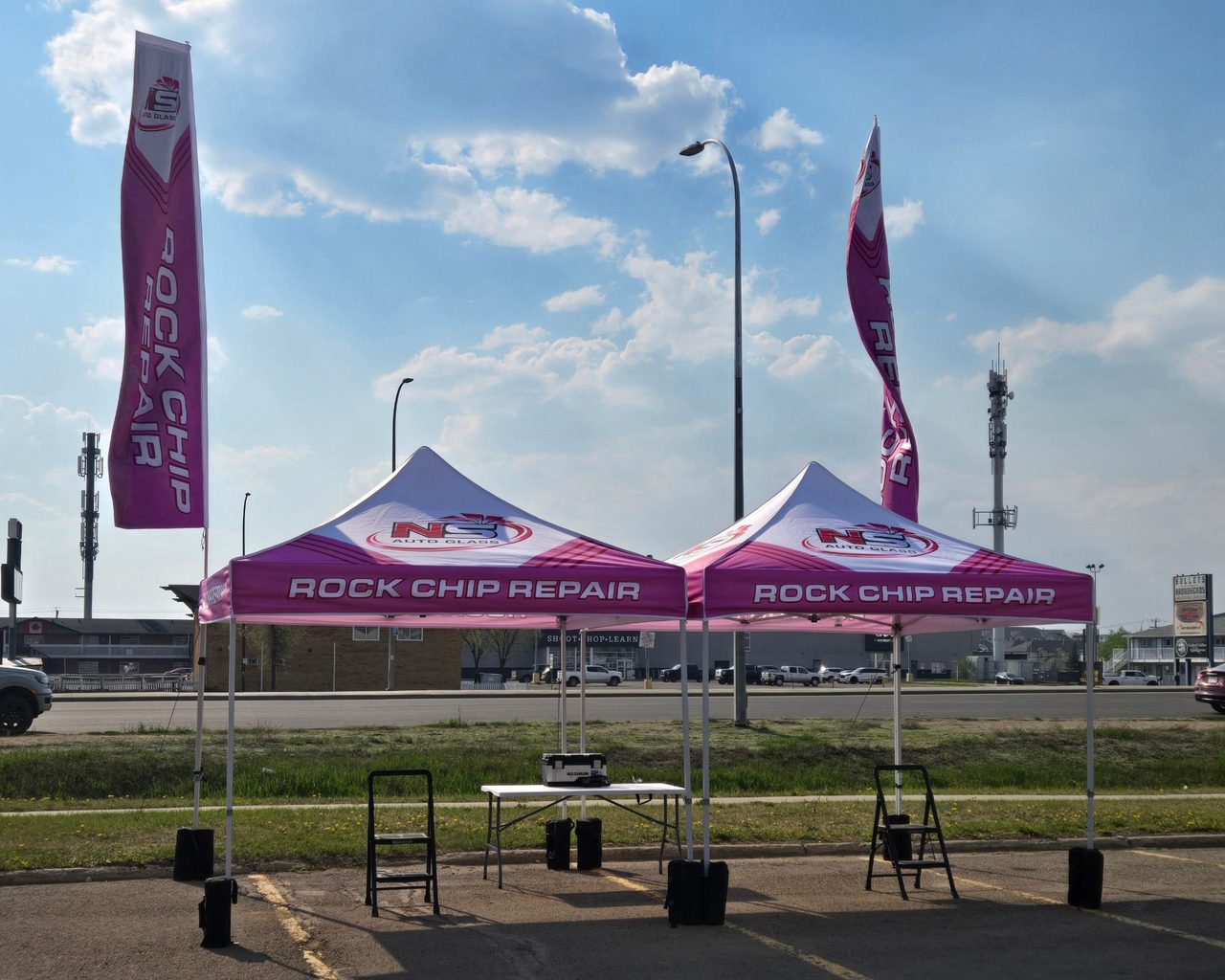 Two pink NS Auto Glass rock chip repair tents in Grande Prairie